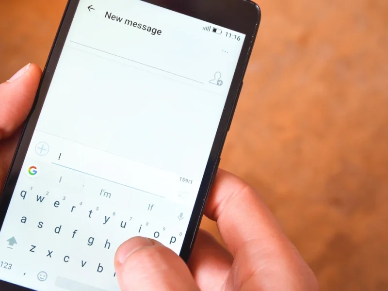 A thumb typing a new text message on a smartphone