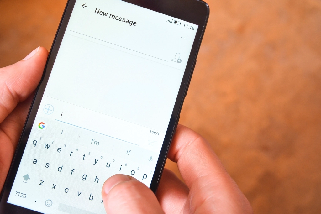 A thumb typing a new text message on a smartphone